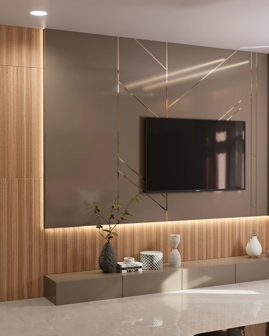 Interior design and modular kitchen work by Homeland Civil Tech, Trivandrum — Living room TV unit in timber panelling with concealed cove lighting and a display ledge